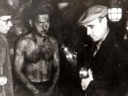 Gheorghe Gheorghiu-Dej printre muncitorii mineri în minele de la Petrila, la 300 m adâncime (1944 noiembrie 23).